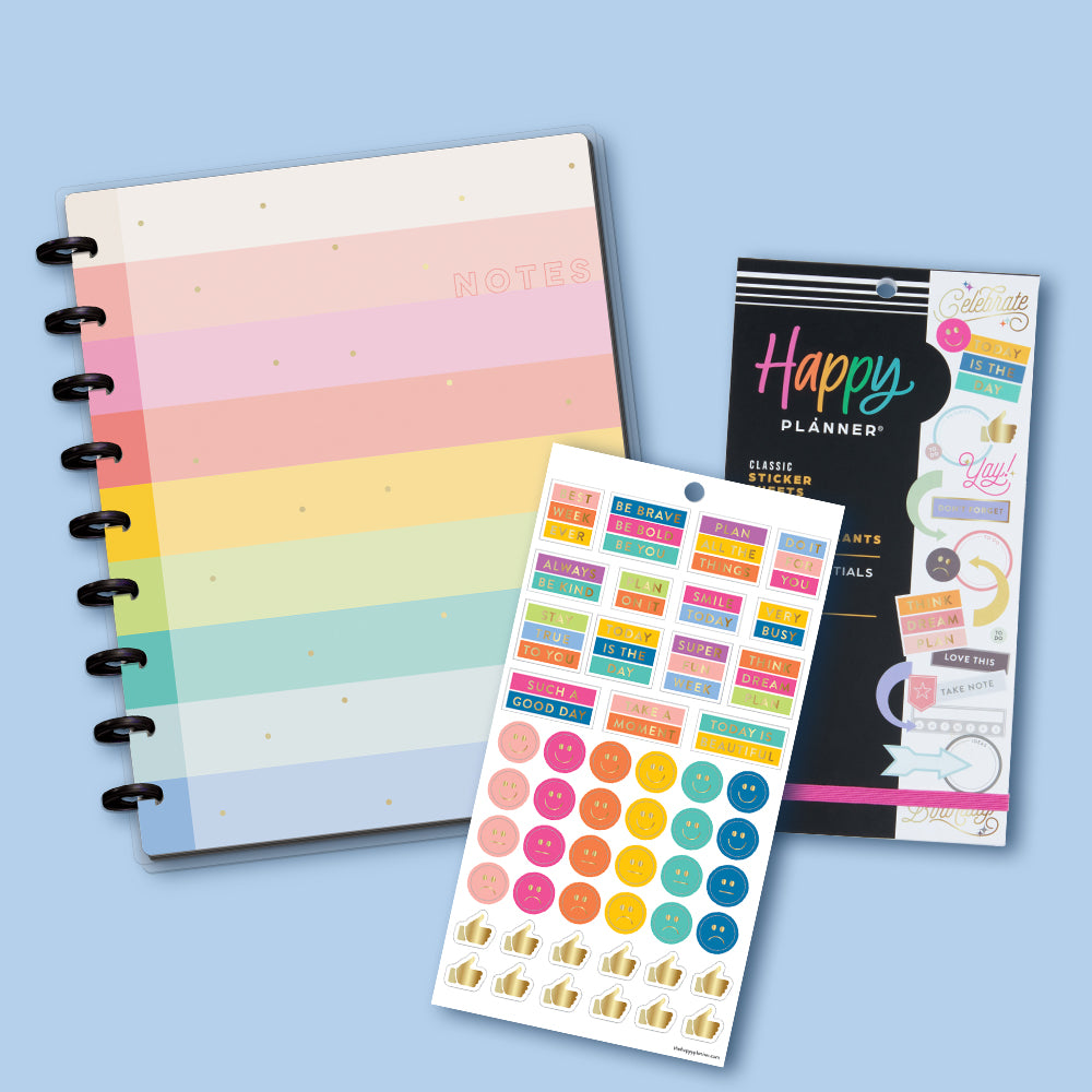 Image of an essential rainbow notebook, and planners stickers