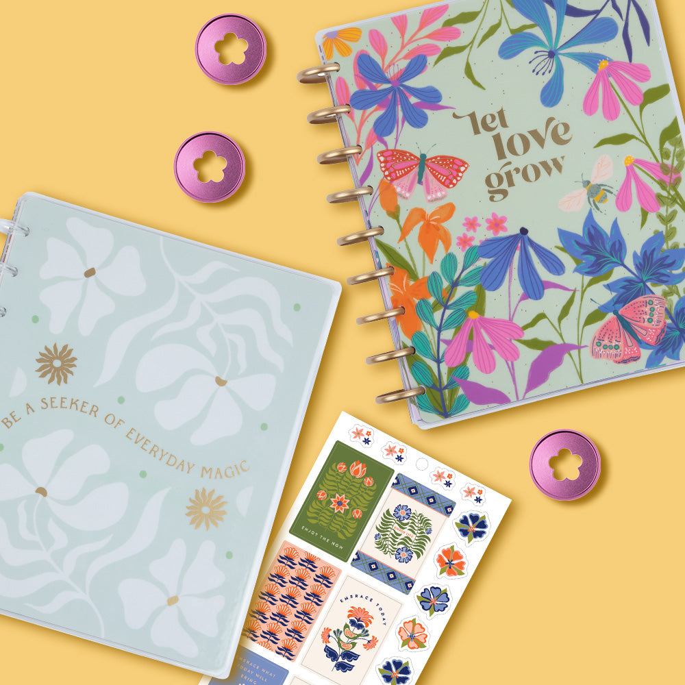 Image of Happy Planner's new Spring 2024 collection featuring a floral planner, pink discs, floral notebook and floral stickers